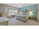 Cozy main bedroom featuring a bay window, ceiling fan, and comfortable furniture at 20394 N Coronado Way, Surprise, AZ 85374