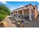 Entertain on the large covered patio with stylish seating, BBQ area, and beautiful views of the desert landscape at 20394 N Coronado Way, Surprise, AZ 85374