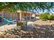 Home exterior showing a patio with outside furniture, a grill, and desert landscaping at 20394 N Coronado Way, Surprise, AZ 85374