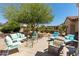 Relaxing patio area with comfortable seating, lush greenery, and serene backyard views at 20394 N Coronado Way, Surprise, AZ 85374