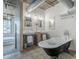 Well-lit bathroom with dual sinks, a classic clawfoot tub, and neutral tile flooring at 21 E 6Th St # 316, Tempe, AZ 85281