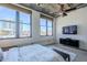 Spacious bedroom featuring large windows with city views, a ceiling fan, and sleek furnishings at 21 E 6Th St # 316, Tempe, AZ 85281