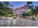 Beautifully maintained building exterior with lush trees, landscaping, tiled sidewalks, and outdoor seating for relaxation at 21 E 6Th St # 316, Tempe, AZ 85281