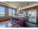 Modern kitchen featuring a large island, stainless steel appliances, dark cabinetry, and exposed ductwork at 21 E 6Th St # 316, Tempe, AZ 85281