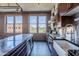 Contemporary kitchen with an island, stone backsplash, stainless steel appliances, and exposed brick, showcasing modern design at 21 E 6Th St # 316, Tempe, AZ 85281