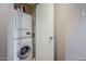 Compact laundry area with a stacked washer and dryer unit in a small closet at 21 E 6Th St # 316, Tempe, AZ 85281