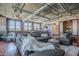 Open-concept living room showcasing a large sectional sofa, exposed brick, a glimpse of the kitchen, and a bedroom at 21 E 6Th St # 316, Tempe, AZ 85281