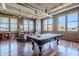 Bright living room featuring a pool table, hardwood floors, exposed duct work, and many large windows offering city views at 21 E 6Th St # 316, Tempe, AZ 85281