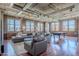 Expansive living room boasting exposed ductwork, brick walls, a pool table, and lots of natural light from numerous windows at 21 E 6Th St # 316, Tempe, AZ 85281