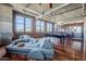 Spacious living room showcasing hardwood floors, a large sofa, a pool table, and an open layout leading to the kitchen at 21 E 6Th St # 316, Tempe, AZ 85281