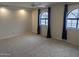 Large bedroom with carpet, ceiling fan and arched windows with curtains at 2142 E Turney Ave # 9, Phoenix, AZ 85016