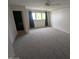 This bright bedroom features a ceiling fan, plush carpet, and a large window at 2142 E Turney Ave # 9, Phoenix, AZ 85016