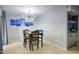 Bright dining room with modern lighting, neutral colors, and adjacent bar area at 2142 E Turney Ave # 9, Phoenix, AZ 85016