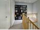 Upstairs hallway with a bookshelf and a view of the stairwell at 2142 E Turney Ave # 9, Phoenix, AZ 85016