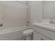 Modern bathroom with a combined shower and tub, complete with sleek fixtures and white tiling at 23404 W Burton Ave, Buckeye, AZ 85326