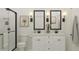 Modern bathroom showcasing a double vanity, stylish mirrors, and a glass-enclosed shower at 23404 W Burton Ave, Buckeye, AZ 85326