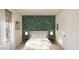 Stylish bedroom with a bed, botanical wallpaper accent wall, and decor at 23404 W Burton Ave, Buckeye, AZ 85326