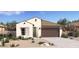 Inviting single-story home with a two-car garage, neutral-toned exterior, and desert landscaping at 23404 W Burton Ave, Buckeye, AZ 85326