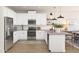 Well-lit kitchen features white cabinets, stainless steel appliances, and a functional island at 23404 W Burton Ave, Buckeye, AZ 85326
