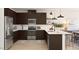 Well-equipped kitchen with stainless steel appliances, dark wood cabinetry, and a functional center island at 23404 W Burton Ave, Buckeye, AZ 85326