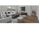 Well-lit living area featuring a large television, contemporary decor, and inviting seating arrangements at 23404 W Burton Ave, Buckeye, AZ 85326