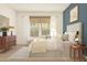 Comfortable main bedroom featuring a bed, bench, neutral decor, and a window with natural light at 23404 W Burton Ave, Buckeye, AZ 85326
