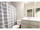 Bathroom featuring a shower with striped curtain, toilet, and sink with mirror at 2554 E Vermont Dr, Gilbert, AZ 85295