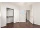 Bedroom featuring wood floors, a closet, connecting door, and neutral paint at 2554 E Vermont Dr, Gilbert, AZ 85295
