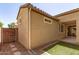 View of stucco exterior of home with tile roof and gated area with grass at 2554 E Vermont Dr, Gilbert, AZ 85295