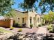 Inviting single-story home featuring a cozy front porch, brick accents, and desert landscaping at 2554 E Vermont Dr, Gilbert, AZ 85295