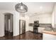 Well-lit kitchen features stainless steel appliances, white cabinets, and sleek countertops at 2554 E Vermont Dr, Gilbert, AZ 85295