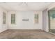 Bright, neutral room featuring carpet flooring, multiple windows, and a sliding glass door at 2554 E Vermont Dr, Gilbert, AZ 85295