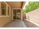 Covered patio featuring a sliding glass door, rock features, and a block wall at 2554 E Vermont Dr, Gilbert, AZ 85295