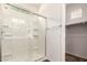 Modern glass enclosed shower with tile and a view of the closet at 2554 E Vermont Dr, Gilbert, AZ 85295
