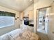Well-lit bedroom with built-in cabinets, TV, and a view into the hallway at 272 S Cinnabar Dr, Apache Junction, AZ 85119