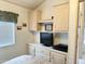Functional bedroom design features a built-in TV cabinet with drawers, shelving, and bright decor at 272 S Cinnabar Dr, Apache Junction, AZ 85119