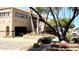 Charming community building framed by lush trees and vibrant flowerbeds at 272 S Cinnabar Dr, Apache Junction, AZ 85119
