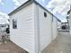 Exterior view with white siding and a sidewalk leading to a nearby community at 272 S Cinnabar Dr, Apache Junction, AZ 85119