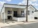 Charming mobile home featuring a covered porch with outdoor seating and tidy, low maintenance landscaping at 272 S Cinnabar Dr, Apache Junction, AZ 85119