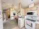 Efficient kitchen adjacent to the dining area, equipped with modern appliances and ample storage at 272 S Cinnabar Dr, Apache Junction, AZ 85119
