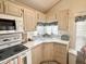 Kitchen features a corner sink with view window and plenty of cabinet storage at 272 S Cinnabar Dr, Apache Junction, AZ 85119