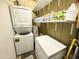 Functional laundry area equipped with stacked washer-dryer and shelving for storage at 272 S Cinnabar Dr, Apache Junction, AZ 85119