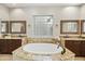 Elegant bathroom featuring a soaking tub with granite surround, dual sinks, and stylish fixtures at 2727 S Balboa Dr, Gilbert, AZ 85295