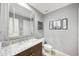 Well-lit bathroom featuring granite countertops, a large mirror, and under-sink storage cabinet at 2727 S Balboa Dr, Gilbert, AZ 85295