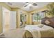 Comfortable bedroom with a ceiling fan, large bed, and a view of the outside at 2727 S Balboa Dr, Gilbert, AZ 85295