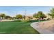 Community park area featuring a winding pathway, grassy area and trees at 2727 S Balboa Dr, Gilbert, AZ 85295