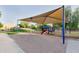 Shaded community playground with a slide and play structure surrounded by lush greenery and a sidewalk at 2727 S Balboa Dr, Gilbert, AZ 85295