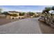 Paver driveway leads to the home, surrounded by mature desert landscaping, creating a welcoming entrance at 2727 S Balboa Dr, Gilbert, AZ 85295
