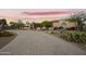 A well-manicured circular driveway leading to a beautiful home with lush desert landscaping at 2727 S Balboa Dr, Gilbert, AZ 85295