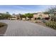 Circular paver driveway showcasing desert landscaping and a charming entry gate to this well-maintained home at 2727 S Balboa Dr, Gilbert, AZ 85295